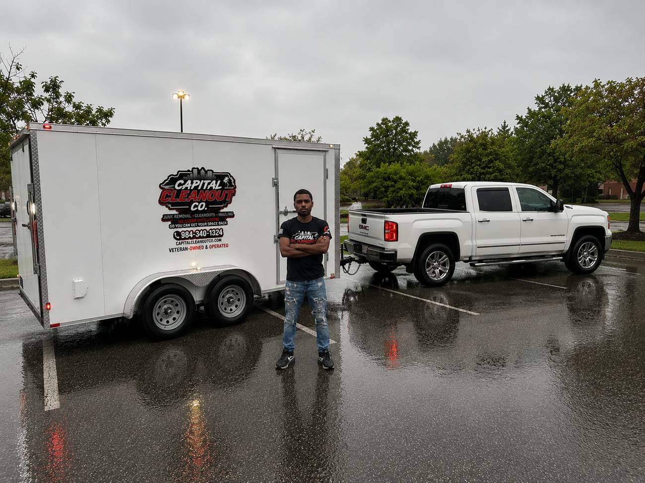 Darien Myers, veteran owner of Capital Cleanout Co., standing with his branded junk removal trailer and truck in Raleigh NC